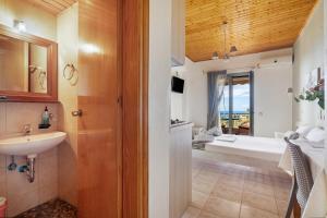 a bathroom with a sink and a bath tub at Nontas Homes 32 in Kalamitsi +23 photos