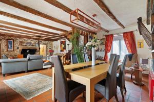 a dining room and living room with a table and chairs at Chambre Grany - Chambre in Aucaleuc