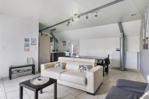 a living room with a couch and a table at L'aérostier Gîte - 5 Pers in Saint-Georges-sur-Cher