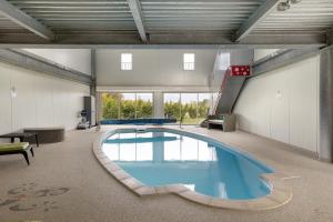 a large swimming pool in a large room at L'aérostier Gîte - 5 Pers in Saint-Georges-sur-Cher