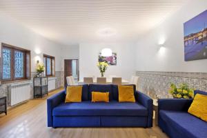 a living room with blue couches and a table at Douro Garden House and Pool in Vila Nova de Gaia