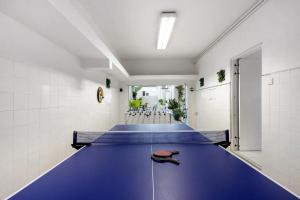 a blue ping pong table in a gymnasium at Douro Garden House and Pool in Vila Nova de Gaia
