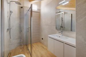 a bathroom with a shower and a sink and a mirror at Chalet Serenella in Valdidentro +82 photos