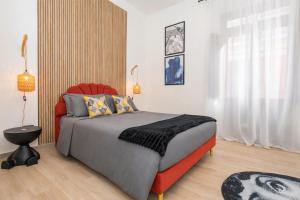 a bedroom with a bed and a red chair at MSuite Etna Sicily in Macchia