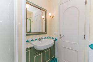 a bathroom with a sink and a mirror at La Terrazza sul Mare in Liscia di Vacca
