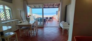 a kitchen and dining room with a view of the ocean at La Terrazza sul Mare in Liscia di Vacca
