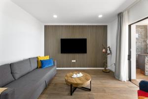 a living room with a couch and a tv at Casa Llano del Rey in Arona