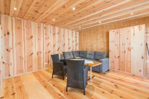 a room with a table and chairs and wooden walls at Bungalow 7 - Anglerinsel in Kollm