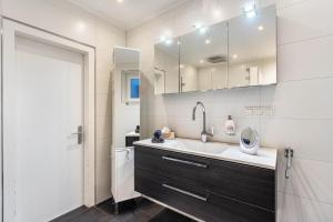 a bathroom with a sink and a mirror at Exklusives Loft mit Kamin in Bad Salzuflen +21 photos