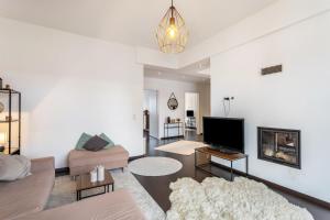a living room with a couch and a tv at Exklusives Loft mit Kamin in Bad Salzuflen