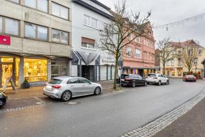 a row of cars parked on a city street at Exklusives Loft mit Kamin in Bad Salzuflen