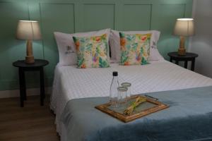 a bedroom with two beds with a tray on the bed at Villa Jerusalém - Casa de Campo in Romeu +36 photos