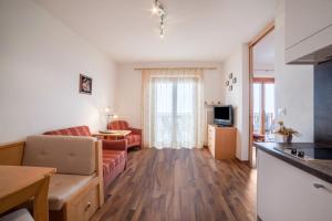 a living room with a couch and a table at Haus Hohenrain Ferienwohnung 3 in Schenna