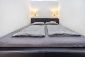a bed in a bedroom with two pillows on it at Altenbeken- Ferienwohnung 1 in Altenbeken