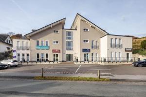 a large building with a parking lot in front of it at Altenbeken- Ferienwohnung 1 in Altenbeken