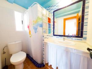 a bathroom with a toilet and a sink at Casas Pepe 5 Bungalow in Los Caños de Meca