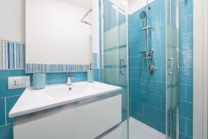 a bathroom with a sink and a shower at Da doddo e beby in Santa Margherita di Pula +16 photos