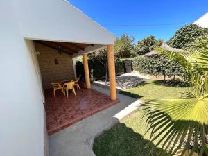 a patio of a house with a table and chairs at Casas Pepe 5 Bungalow in Los Caños de Meca +9 photos