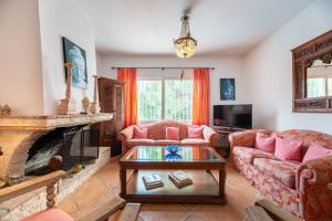 a living room with a couch and a fireplace at Villa Renate in Sant Josep de sa Talaia