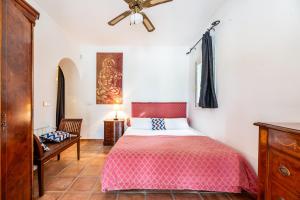 a bedroom with a bed and a ceiling fan at Villa Renate in Sant Josep de sa Talaia +30 photos