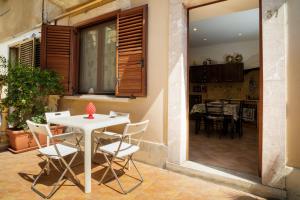 a white table and chairs on a patio at Casa Carly Taormina in Taormina