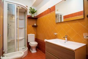 a bathroom with a toilet and a sink and a shower at Casa Carly Taormina in Taormina +11 photos