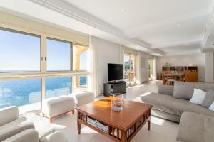 a living room with a couch and a table at Villa Mina - First Line Villa in El Campello