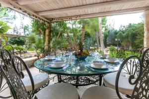 a table and chairs on a patio at Villa Riggia - La Masseria in Nardò