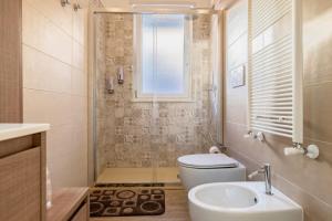 a bathroom with a toilet and a sink at Casadamare Salento in Brindisi +10 photos