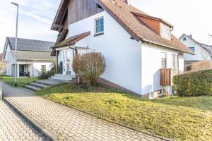 a white house with a brown roof at Angie's Ferienapartment Thermalbad in Bad Staffelstein