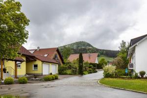 a row of houses with a mountain in the background at Fewo unterm Dreifaltigkeitsberg in Balgheim