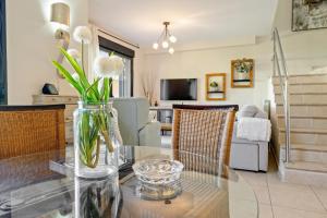 a glass table with white flowers in a vase on it at Casa Emi in Cambrils