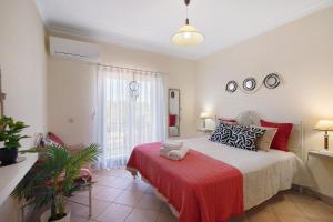 a bedroom with a bed with a red blanket at J R Dream house in Quarteira +27 photos