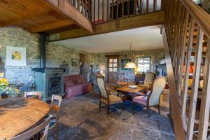 a living room with a staircase and a table and chairs at Villa L'elzède 2-6 personnes in Les Vans