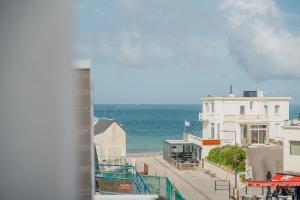 a view of the beach and the ocean from a building at Le Saint Martin Duplexe à la Mer in Bréhal