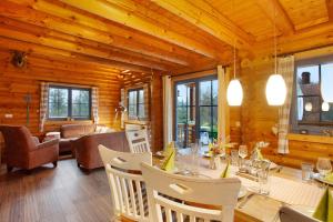 a dining room with a table and chairs at Holzhaus Mühlenblick mit Whirlpool in Medebach