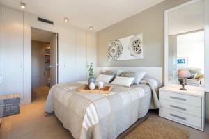 a bedroom with a bed with a tray on it at Apartamento Ballena in Cambrils +13 photos