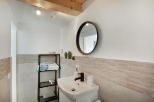 a bathroom with a sink and a mirror at Villa Monica B in Agüimes +16 photos
