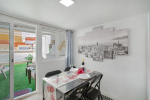 a dining room with a table and a window at Villa Monica B in Agüimes