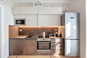 a kitchen with stainless steel appliances and a refrigerator at Villa Traimari in Trani