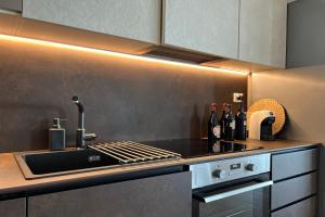 a kitchen with a sink and a stove top oven at Villa Traimari in Trani +31 photos
