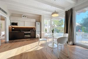 a kitchen and dining room with a table and chairs at Villa Traimari in Trani