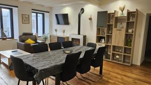 a living room with a dining room table and chairs at gite in Saint-Vaast-la-Hougue