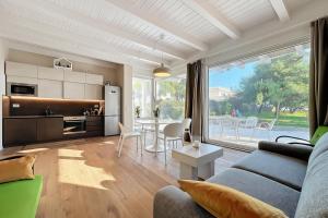 a living room with a couch and a table with chairs at Villa Traimari in Trani