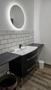 a bathroom with a sink and a mirror at gite in Saint-Vaast-la-Hougue