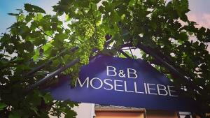 a blue sign that reads bb mossellie in a tree at Haus Moselliebe Komfortzimmer in Ediger-Eller +2 photos