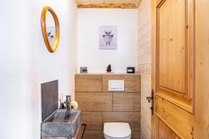 a bathroom with a sink and a toilet and a mirror at Haus Glückswiese in Großhartberg +31 photos