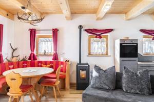 a living room with a couch and a table at Haus Glückswiese in Großhartberg