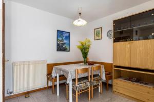 a dining room with a table and chairs at Appartamento Al Sasso Rosso Dimaro in Dimaro