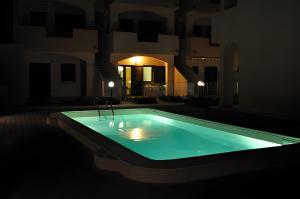 a swimming pool at night in a dark room at Casa vacanza La Rosa dei Venti in Viddalba